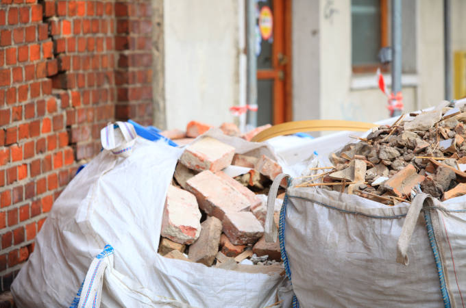 Full construction waste debris bags, garbage bricks and material from demolished house