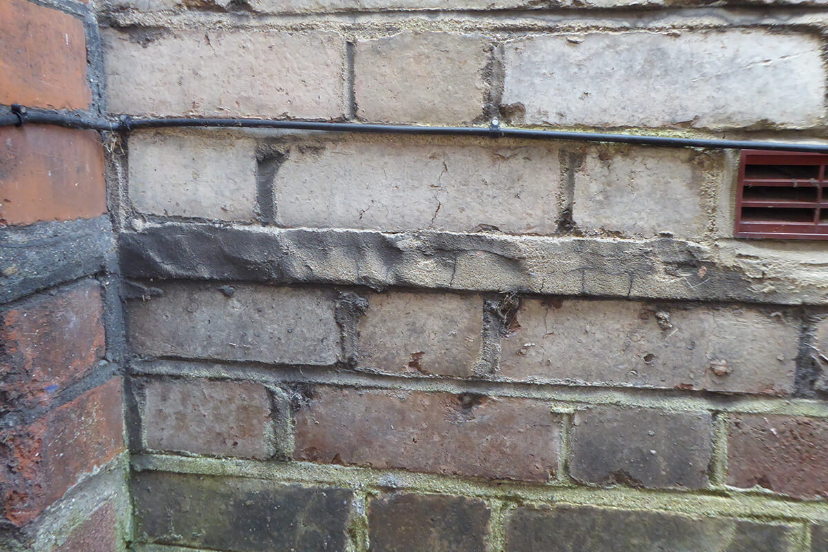 Slate damp proof courses are usually hidden behind the wide mortar joint