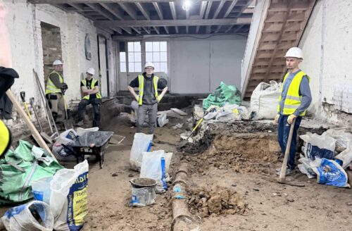 Interior refurbishment of a commercial property in London with exposed brickwork, timber framing and roof trusses