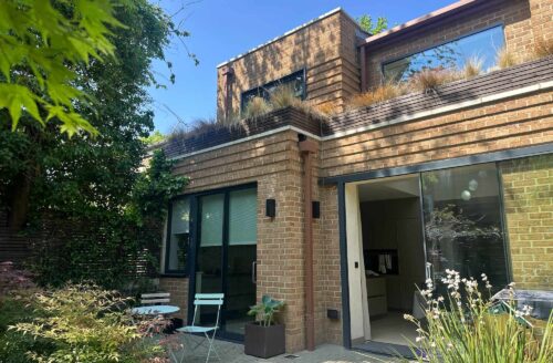 Modern rear extension to a London property with brickwork, large glazed doors and landscaped garden