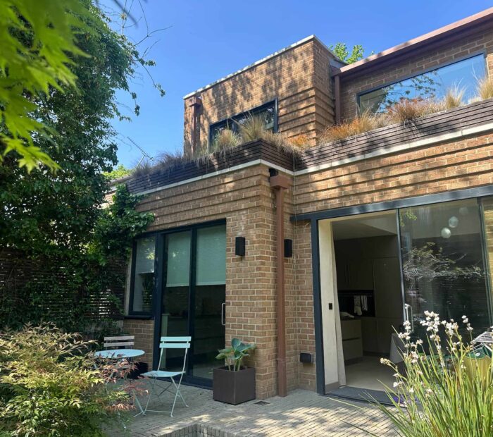 Modern rear extension to a London property with brickwork, large glazed doors and landscaped garden