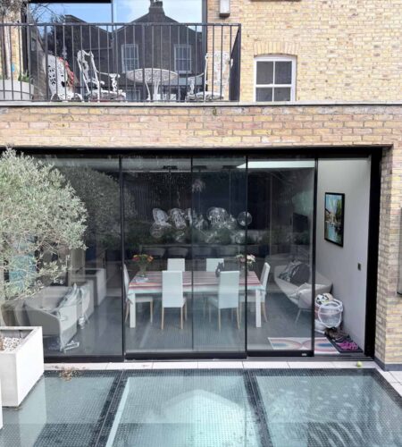 Rear extension to a London property with full-height glazed doors and contemporary terrace