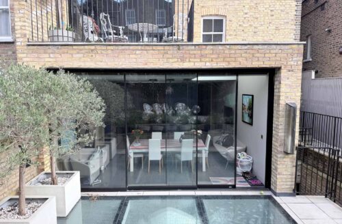 Rear extension to a London property with full-height glazed doors and contemporary terrace