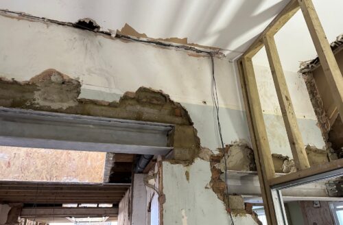 Steel beam installation and exposed masonry during structural alterations to a London property