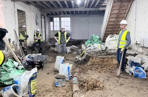 Interior refurbishment of a commercial property in London with exposed brickwork, timber framing and roof trusses