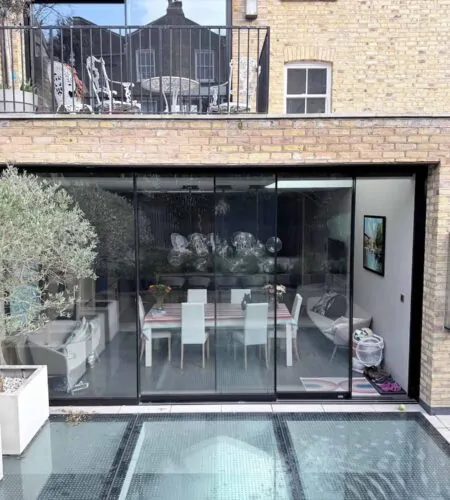 Rear extension to a London property with full-height glazed doors and contemporary terrace
